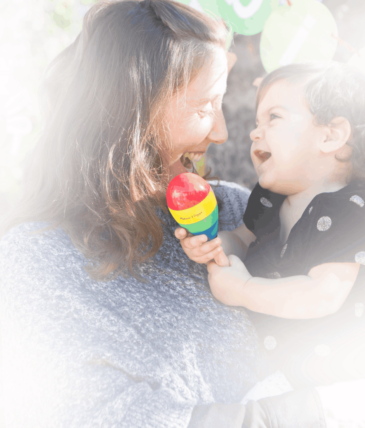 Lisa Klaus smiling with a young child outdoors